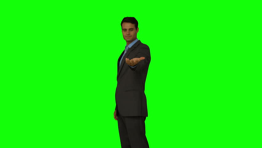 Portrait Of Young Man Standing Against Green Screen. Male Person ...